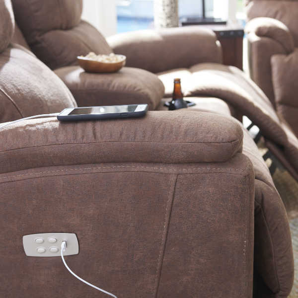 iPhone plugged into power reclining sofa