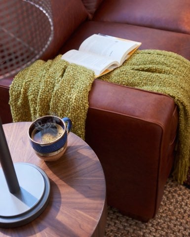 Closeup of Meyer Sofa arm and table with book and coffee