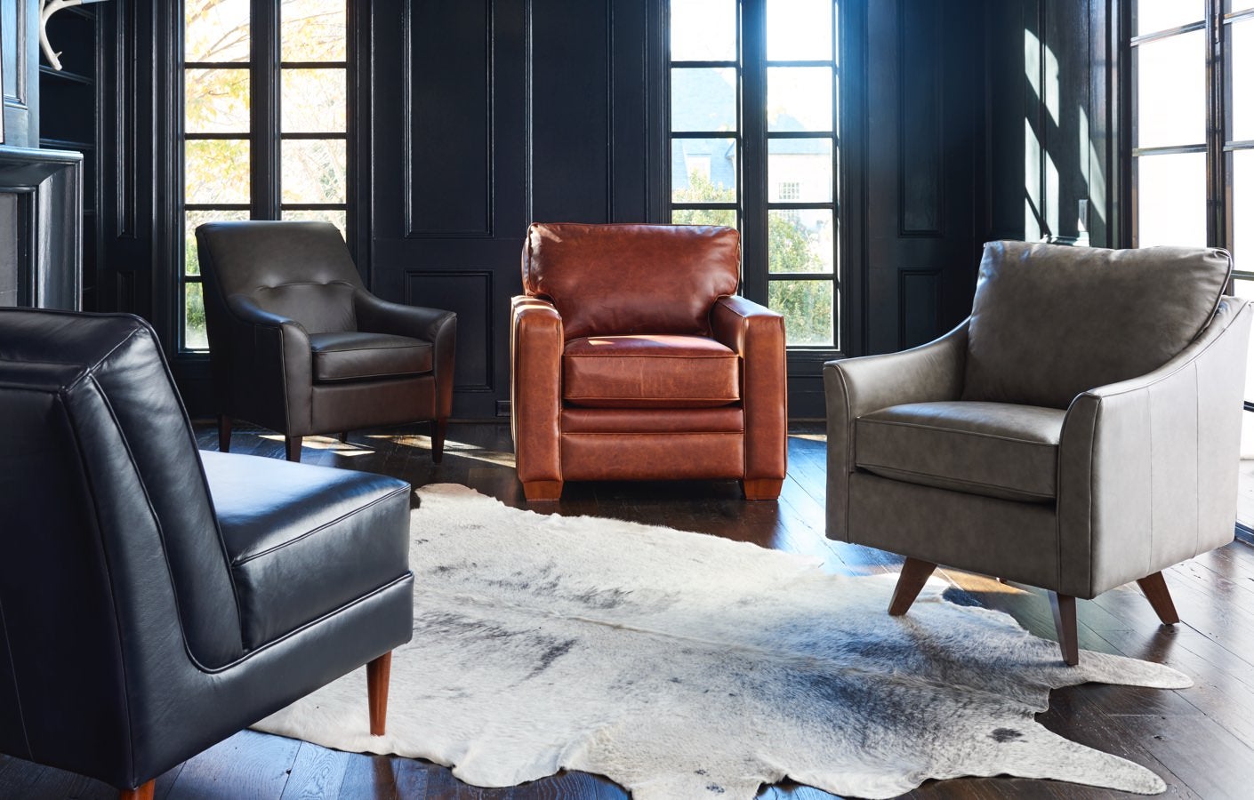 Room scene with leather chairs and rug