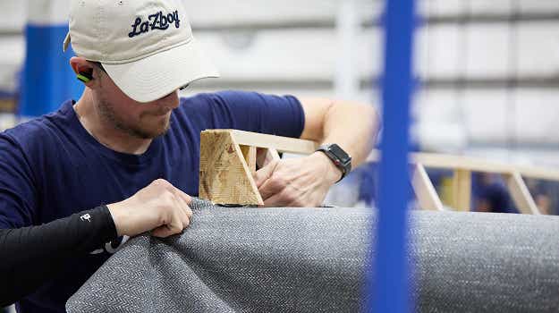 a La-Z-Boy employee working on building a recliner
