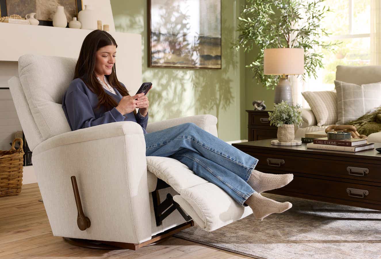 A woman sitting at home on her phone taking the recliner quiz