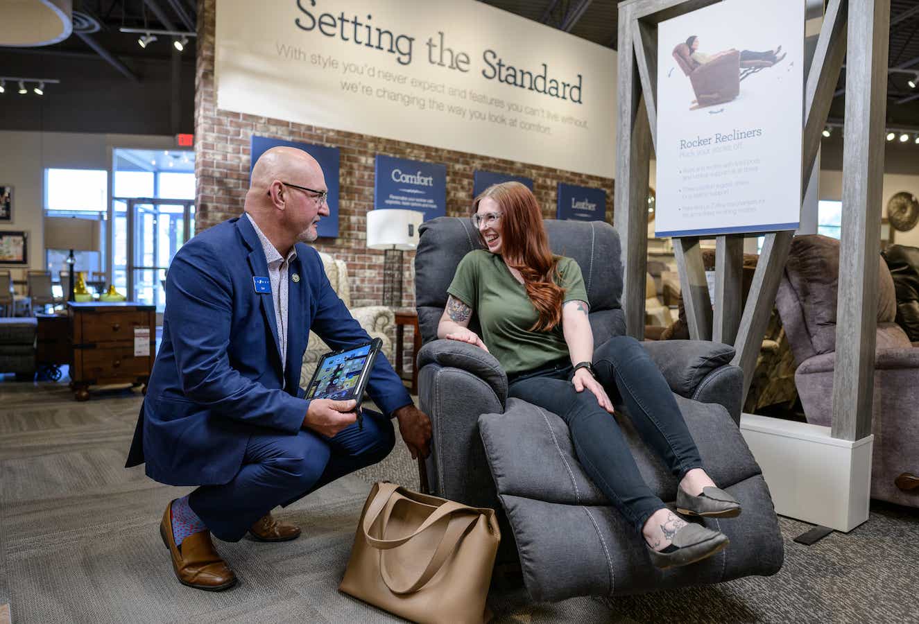 A sales associate helping customers at a La-Z-Boy store