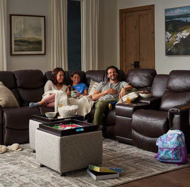 a family relaxing on a sectional