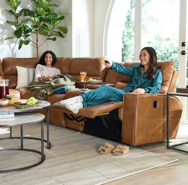 two friends relaxing on a sectional