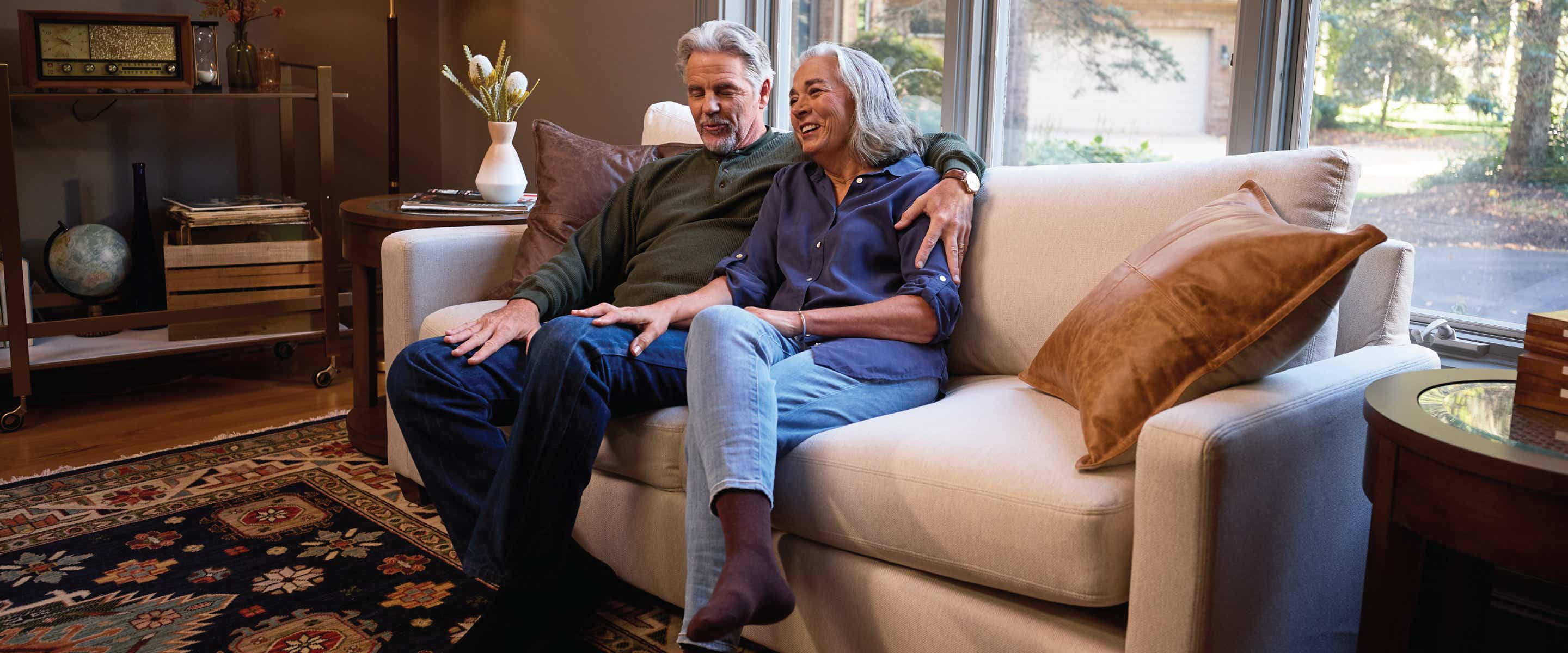A couple sitting a La-Z-Boy Sofa relaxing